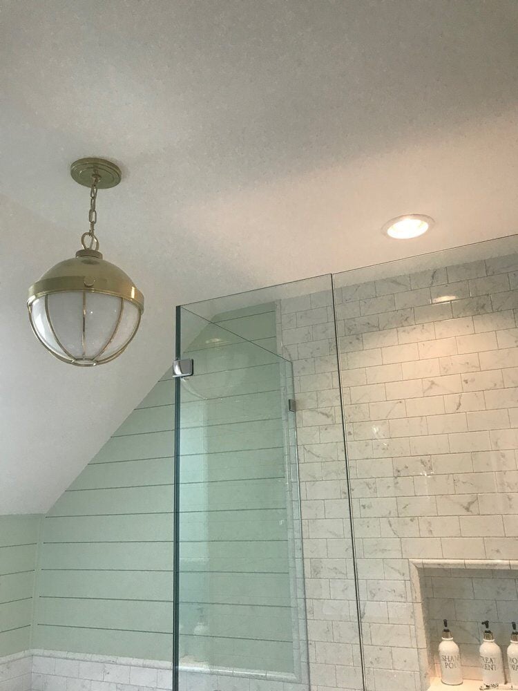 Ceiling light fixture with nautical design in a New Seabury bathroom remodel