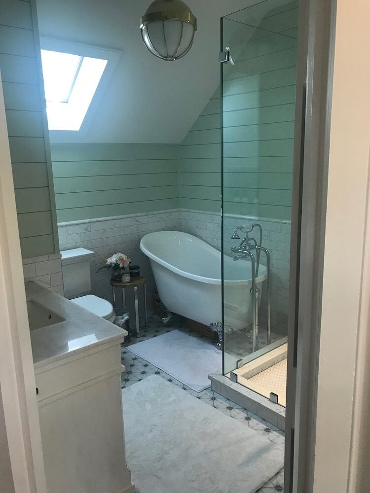 Luxurious bathroom in New Seabury with natural light from skylight and elegant fixtures