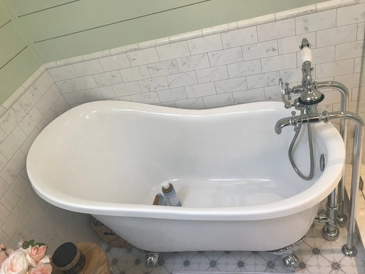 Luxurious freestanding bathtub with elegant chrome fixtures in a New Seabury bathroom