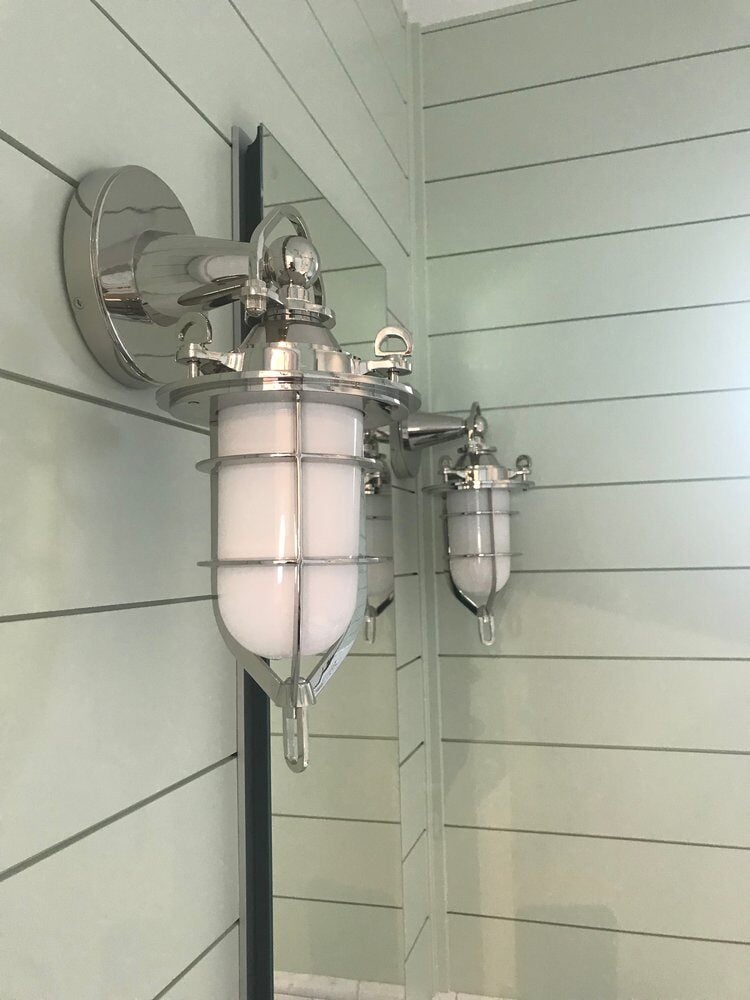 Nautical-style chrome wall sconce in a New Seabury bathroom remodel