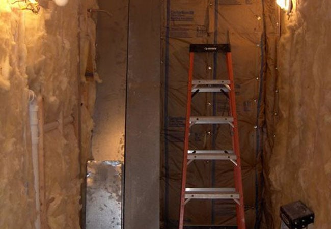 Bathroom remodel in progress showing wall insulation in New Seabury by At Design Remodel, Mashpee