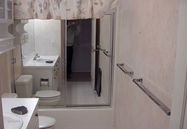 Bathroom with vanity and mirror setup in New Seabury remodel by At Design Remodel, Mashpee