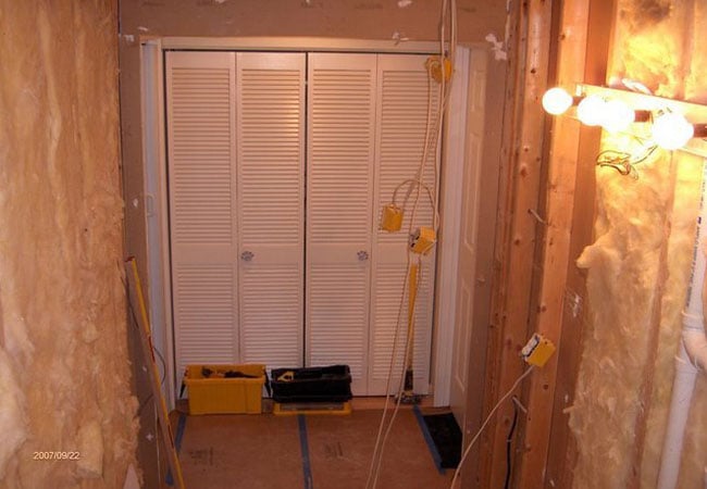 Closet framing in progress during bathroom remodel in New Seabury by At Design Remodel, Mashpee