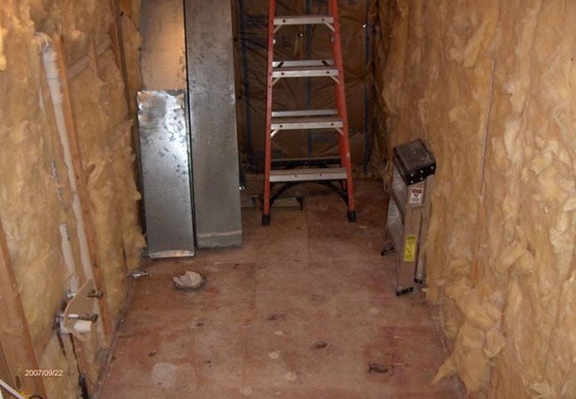 Exposed insulation and tools during bathroom remodel in New Seabury by At Design Remodel, Mashpee