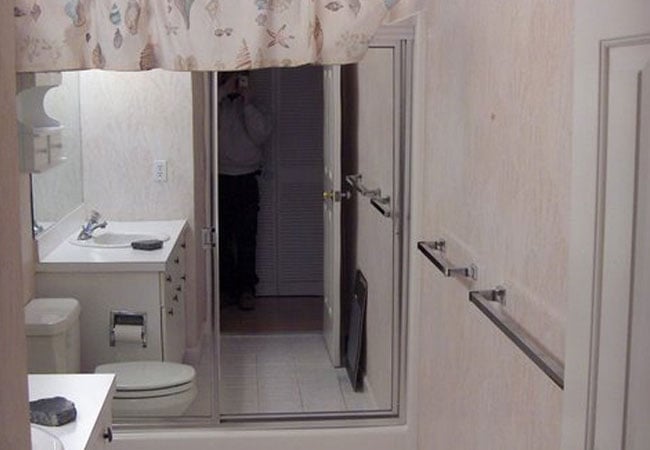 New Seabury bathroom remodel with beige walls and mirrored cabinet, by At Design Remodel, Mashpee