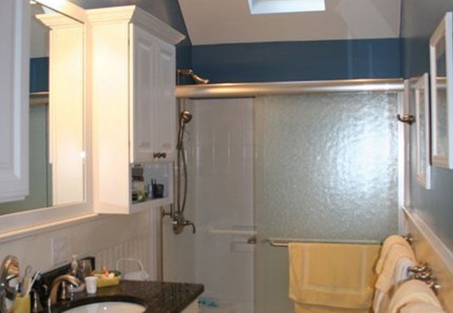 New Seabury bathroom remodel with sliding shower door and skylight by At Design Remodel, Mashpee