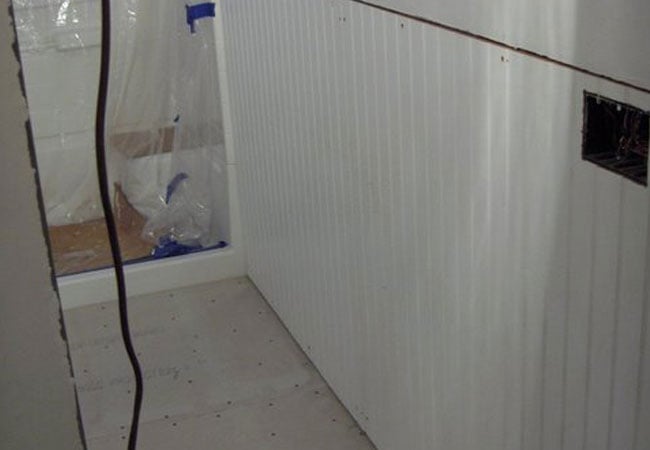 Paneling installation in progress in New Seabury bathroom remodel by At Design Remodel, Mashpee