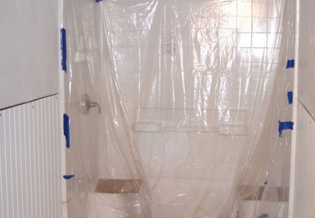 Plastic covering installed over shower during bathroom renovation in New Seabury by At Design Remodel, Mashpee