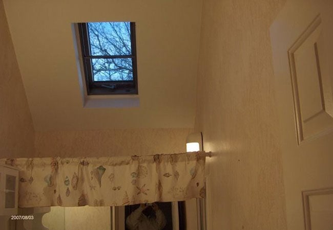 Skylight above shower curtain in New Seabury bathroom remodel by At Design Remodel, Mashpee