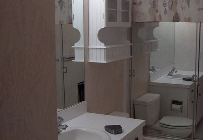 Vanity and storage unit in beige bathroom remodel by At Design Remodel in New Seabury, Mashpee