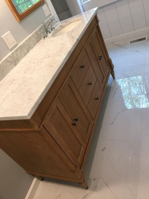 Elegant marble vanity countertop in Mashpee bathroom remodel by At Design Remodel