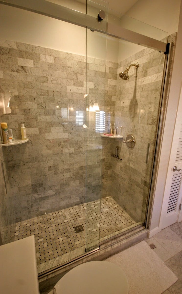 Elegant bathroom with marble vanity and brass fixtures, part of New Seabury Mews condo remodel by At Design Remodel