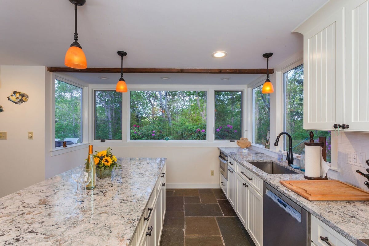 Renovated kitchen in North Falmouth featuring large windows and a spacious island