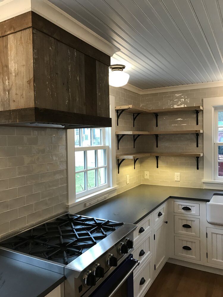 Custom shelving and subway tile backsplash in a remodeled Falmouth kitchen by At Design Remodel