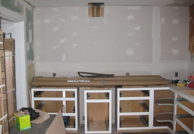 Cabinetry framework being installed during a kitchen remodel in West Falmouth by At Design Remodel