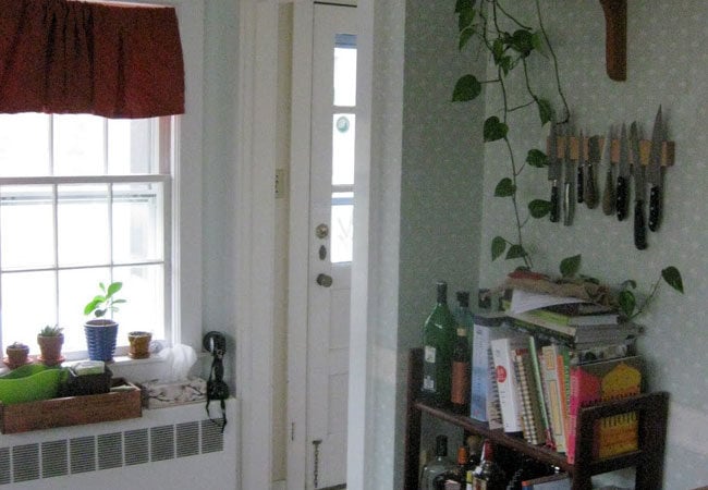 Corner kitchen nook featuring a knife holder and plants as part of a West Falmouth remodel by At Design Remodel