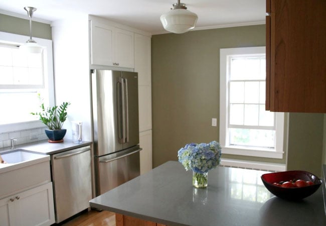 Finished kitchen with stainless steel appliances and hydrangea centerpiece in West Falmouth by At Design Remodel