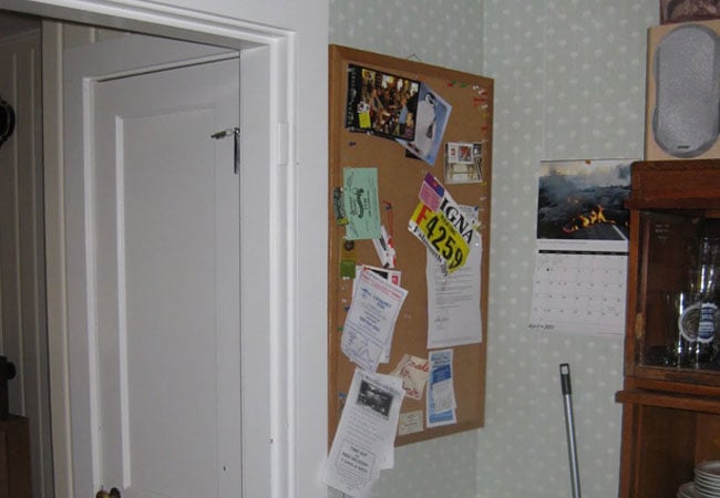 Kitchen corner with a bulletin board and wall calendar in a remodeled West Falmouth home by At Design Remodel