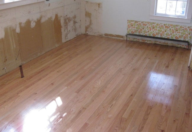 Newly installed hardwood floor in a West Falmouth kitchen remodel by At Design Remodel, Mashpee