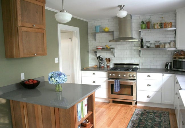 Newly renovated kitchen featuring open shelving, a farmhouse sink, and stainless steel appliances in West Falmouth by At Design Remodel