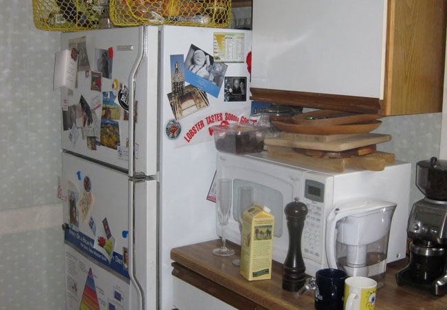 Organized kitchen counter featuring microwave and accessories as part of a remodel in West Falmouth by At Design Remodel