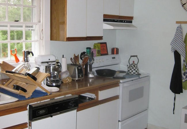 Stove and dish drying rack in a kitchen under remodel in West Falmouth by At Design Remodel, Mashpee