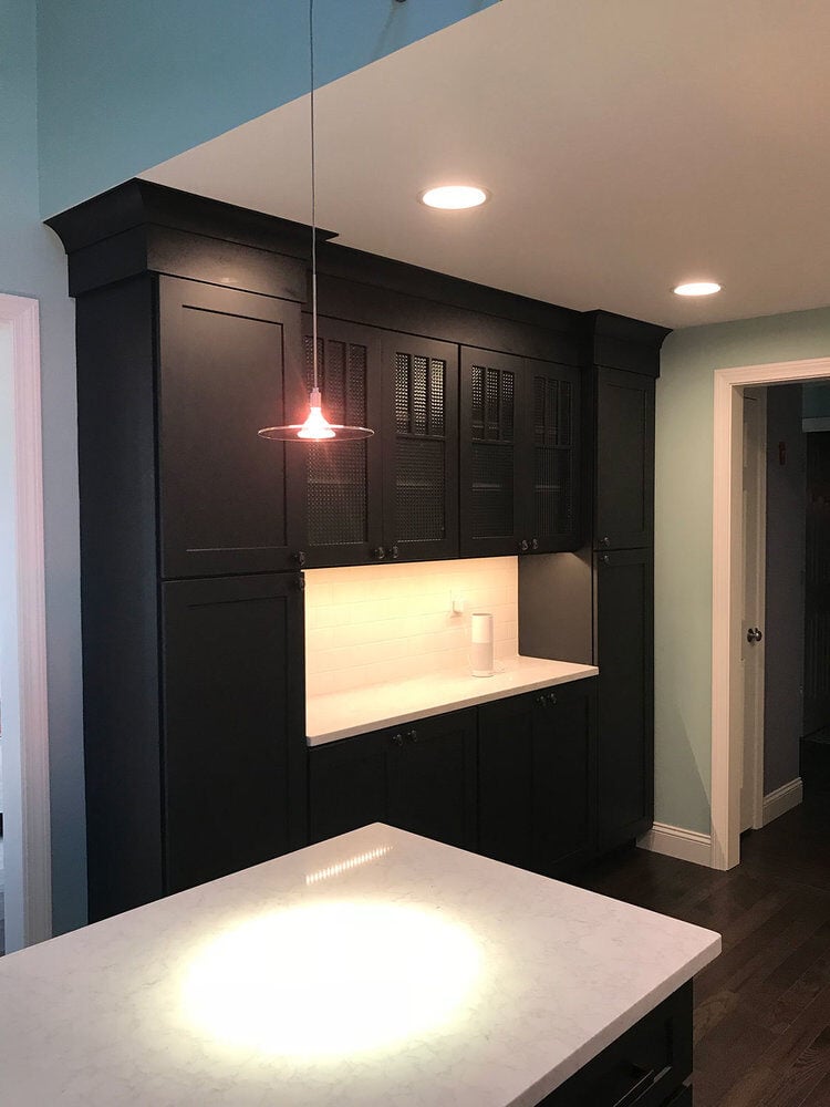 Modern kitchen featuring dark wood cabinetry and recessed lighting in Yarmouthport by At Design Remodel, Mashpee