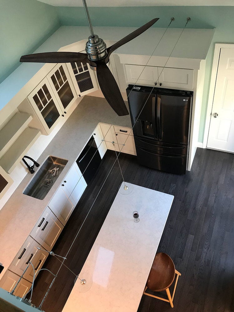 Top-down perspective of kitchen with sleek appliances and island in Yarmouthport remodel by At Design Remodel, Mashpee